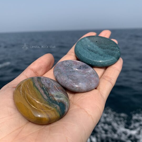 Ocean jasper oval palm stones. Worry stone crystal from Madagascar. Photographed by CrystalRockStar while out at sea.